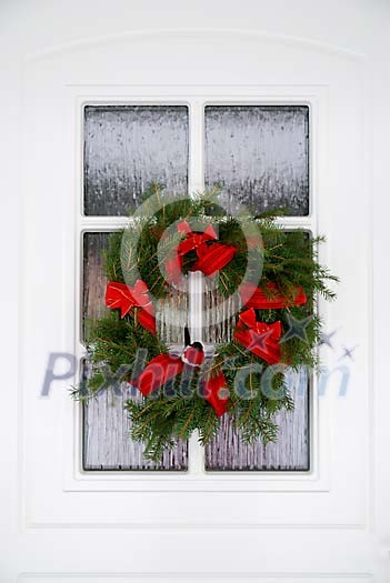 Christmas wreath on a white door