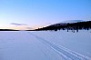 Tracks on arctic lake at sunset