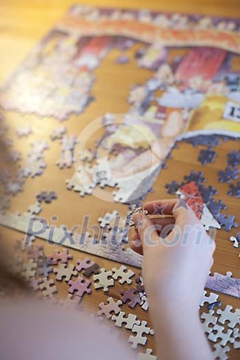 Hands solving a puzzle Hands solving a puzzle