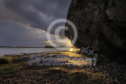 Big rock by the shore at the sunset Big rock by the shore at the sunset