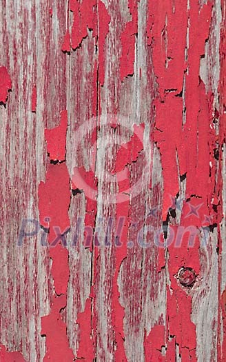 Old red paint on the wooden wall