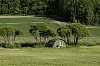 Green tent on a green field