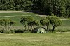 Green tent on a green field