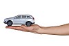 Isolated hand holding a toy car