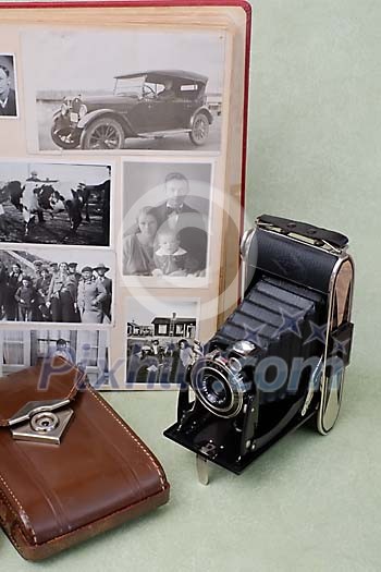 Old photo camera with black and white photo album