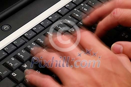 Human hands moving fast on the keyboard