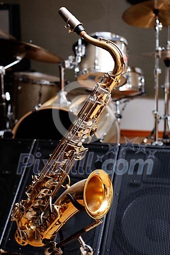 Saxophone infront of drums and speaker