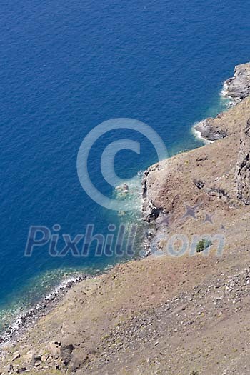 Deep blue sea and hillside shore