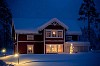 Red wooden house covered in snow.