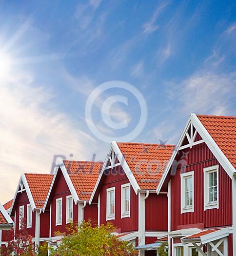 Red wooden houses on a sunny summer day