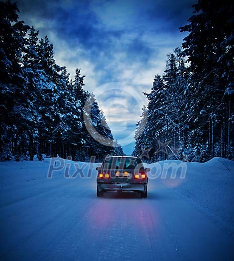 Car on winter road in the forest