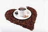 Cup of coffee on the heart made of coffee beans