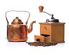 Old coffee grinder and a kettle with coffee beans