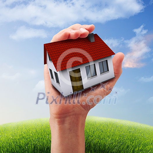 Human hand against blue sky background and house Human hand against blue sky background and house