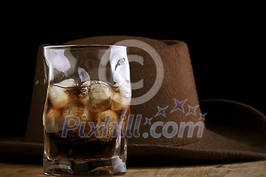 Dark drink with a hat on the background Dark drink with a hat on the background
