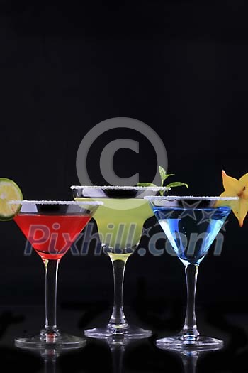 Coloured drinks on a black background Coloured drinks on a black background