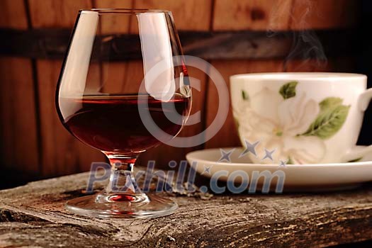Glass of cognac and a cup of coffee Glass of cognac and a cup of coffee