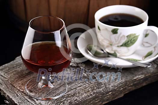 Glass of cognac and a cup of coffee