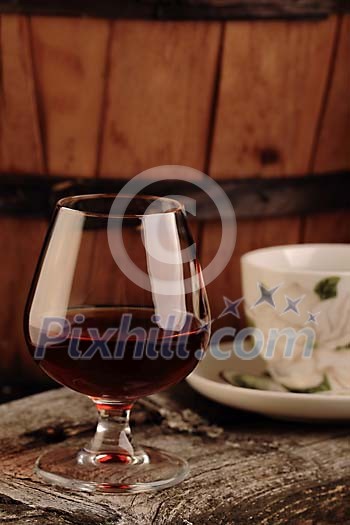 Glass of cognac and a cup of coffee on the table Glass of cognac and a cup of coffee on the table