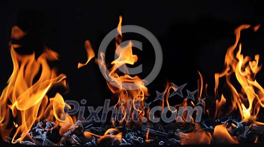 fire and charcoal on a barbecue grill