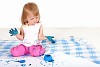 Little girl playing and painting in studio