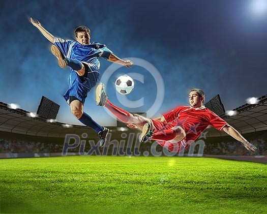 Two football players in jump to strike the ball at the stadium