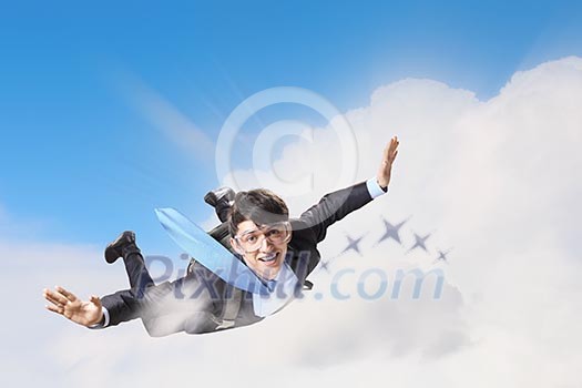 Conceptual image of young businessman flying with parachute on back