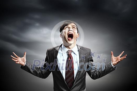 Businessman in anger with fists clenched screaming Businessman in anger with fists clenched screaming