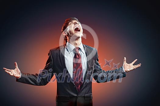 businessman in anger with fists clenched screaming