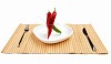 Bright red and bright green chilli pepper rolled into a bun on a white background on a white plate on the table