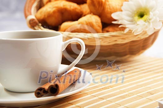 Breakfast coffee and croissants on a table on a light background.