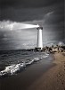 Image of a lighthouse with a strong beam of light