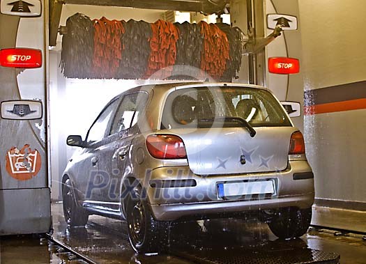 Small car in the automated car wash Small car in the automated car wash