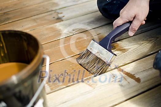 Male hand painting the floor Male hand painting the floor