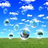 Abstract bubbles against the blue sky and clouds. Symbol of environmental protection. Collage.