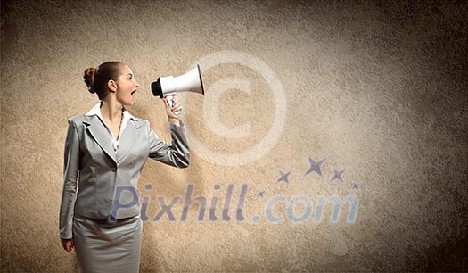 businesswoman in grey suit screaming into megaphone businesswoman in grey suit screaming into megaphone