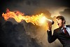 young businessman in black suit screaming into megaphone