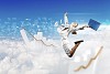 Image of a businesswoman jumping high against blue sky background