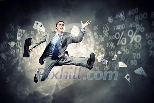 Image of a businessman jumping high against financial background