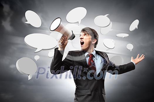 young businessman in black suit screaming into megaphone young businessman in black suit screaming into megaphone