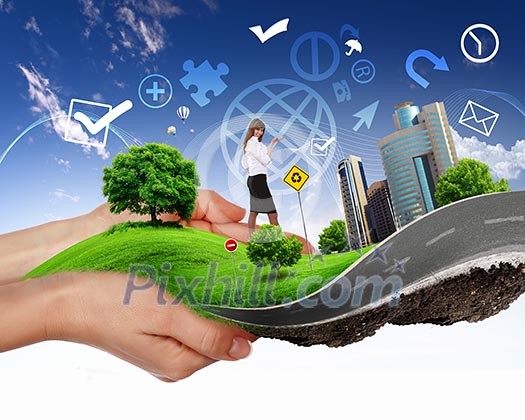 human hand holding a city on green grass hill human hand holding a city on green grass hill