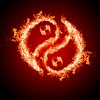 Symbol of yin and yang of the dark background in a flame. The sign of the two elements.