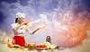 Asian female cooking with magic against color background