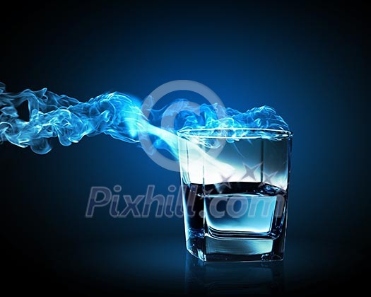 Image of glass of blue cocktail with fume going out Image of glass of blue cocktail with fume going out