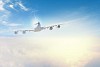 Image of flying airplane in sky with clouds at background