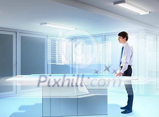 young businessman looking at high-tech image of building model