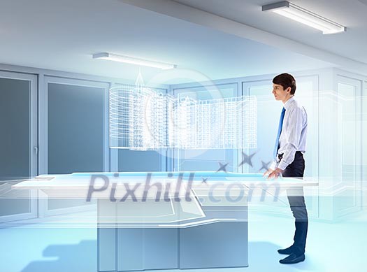 young businessman looking at high-tech image of building model young businessman looking at high-tech image of building model