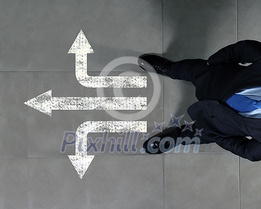 Top view of businessman standing against directions background