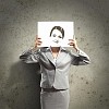Image of businesswoman holding drawing against face. Conceptual photo