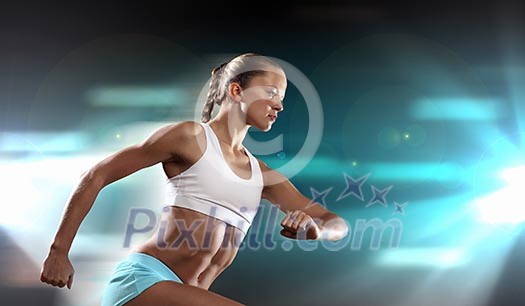 Fitness woman standing against color lights background